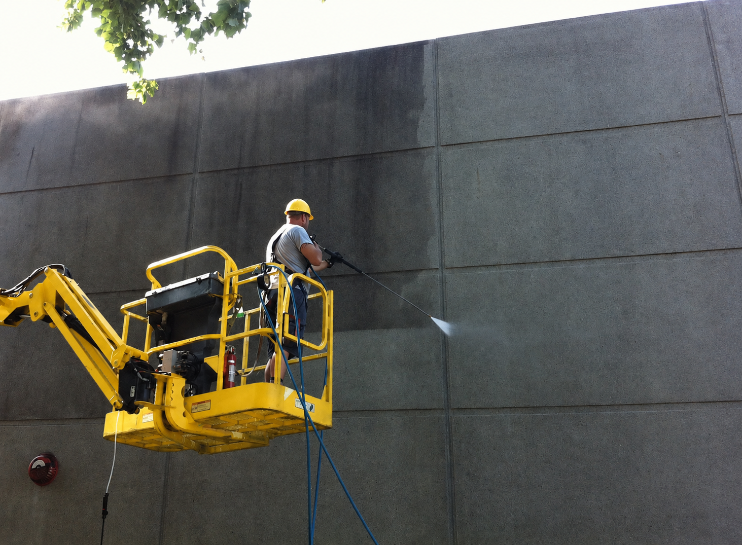 Pressure washing a commercial exterior wall from a boom lift